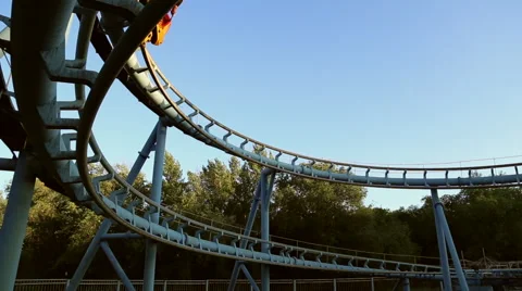 Rollercoaster train is moving along the loop Stock Footage 64745770