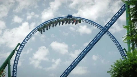 Rollercoaster train moving along loop. Amusement theme park Stock Footage 196162982
