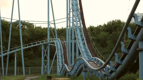 Rollercoaster train is moving along the track Stock Footage 64744352