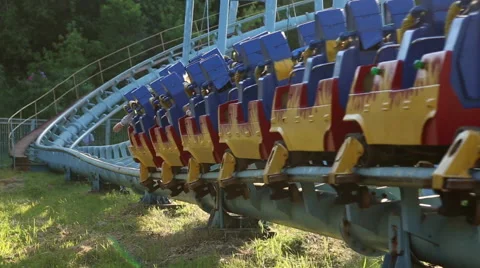 Rollercoaster train is moving along the track Stock Footage 64745749
