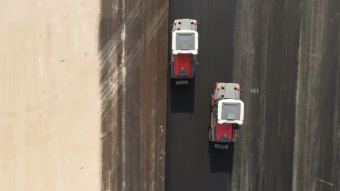 Rollers compact  is driving over freshly poured asphalt, Video stock 146840573