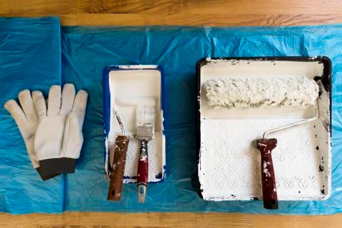 Rollers of different sizes,brush and gloves for painting the walls and ceilin Stock Photos