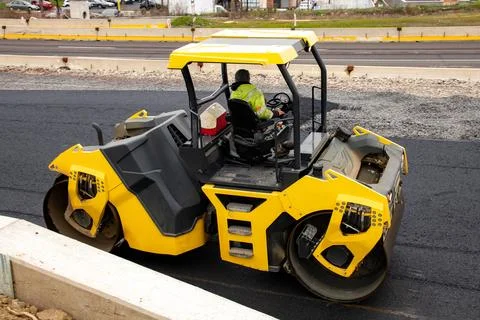 Rollers rollin fresh hot asphalt on the new road road construction Stock Photos