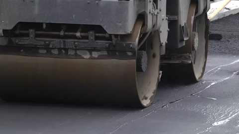 Rollers rolling fresh hot asphalt on the new road. Stock Footage 223819278