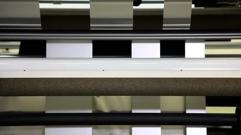 Rollers turn fast on an industrial machine Stockbeeldmateriaal 93747564