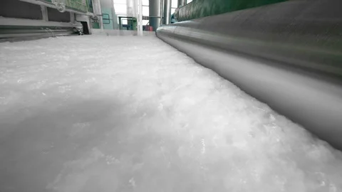 Rollers works with a layer of synthetic fiber on a factory conveyor. Vidéo 111662971