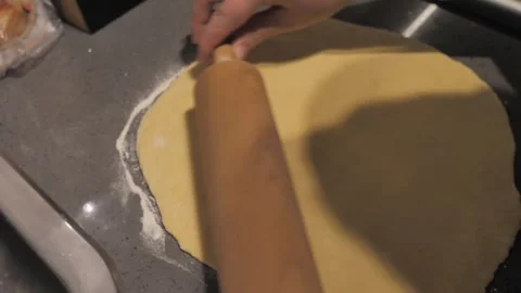 Rollind out dough in the kitchen Stock Footage 299128374