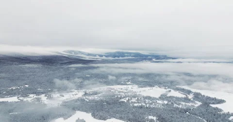 Rolling Adirondack Hills Emerging Through Low Clouds Above Snow Covered Stock Footage 334938995