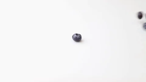 Rolling blueberries isolated on white background. Side view. Stock Footage 127505798