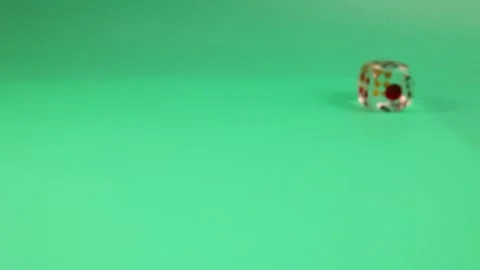 Rolling bouncing play transparent plastic playing dice on green background Stock-Footage 249050238