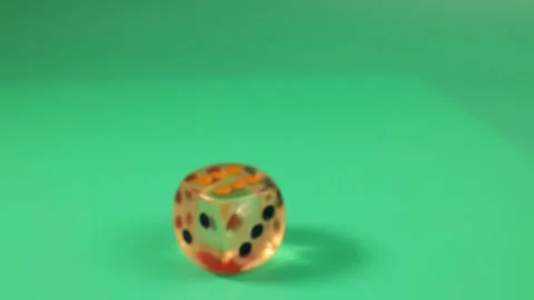 Rolling bouncing play transparent plastic playing dice on green background Stock Footage 249050249