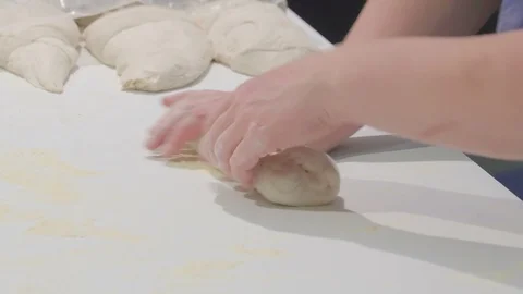 Rolling of a bread dough on the platform table Stock Footage 97699291
