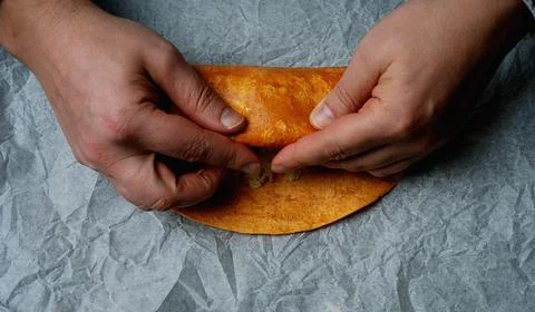 Rolling a burrito on a paper Stock Photos