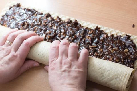 Rolling cake crust with chocolate and jelly candies. Stock Photos