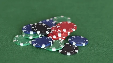 Rolling casino chips on pile in middle of the table Stockbeeldmateriaal 70210828