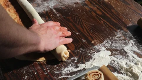 Rolling Cinnamon Sugar Dough into Log Shape During Homemade Cinnamon Roll Stock Footage 310337549