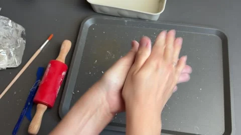 Rolling a clay ball between hands for a small handcrafted pumpkin Stock Footage 345720742