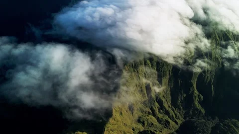 Rolling Clouds Across Mountain Slopes Covering Green Terrain in Warm Daylight Stock Footage 334625875