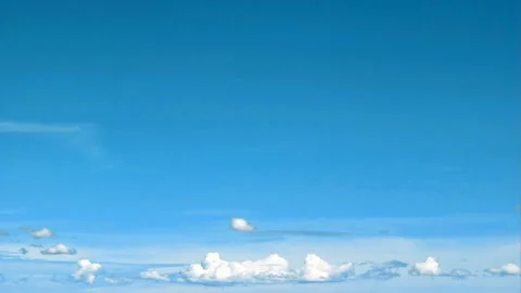 Rolling Clouds Against a Clear Blue Sky During Summer in Time-Lapse Photograp Stock Footage 331691361