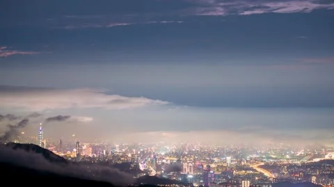 Rolling clouds and city lights enrich the night scene. Stock Footage 265606073