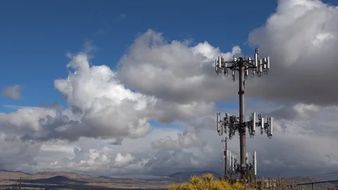 Rolling clouds behind a cell phone tower in the desert Stock Footage 96354757