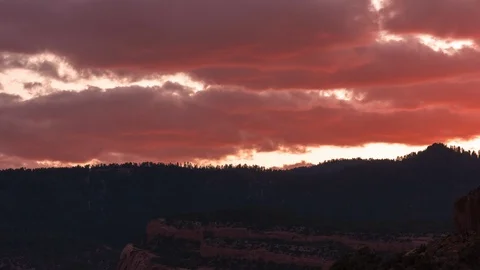 Rolling Clouds over Colorful Sunset timelapses in 4k Video stock 115662191