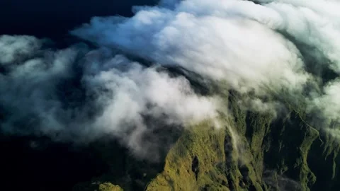 Rolling Clouds Over Mountains with Thick Cloud Cover and Green Slopes in Stock Footage 334624772