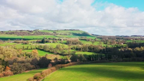 Rolling countryside hills and patchwork fields landscape in UK Stock Footage 333892725