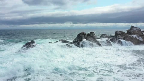 Rolling Crashing Waves Splashing Against Lava Rock in Black Sea Stock Footage 176700172