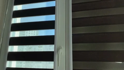 Rolling up curtains on the window Stock Footage 139275223