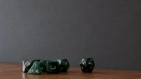 Rolling a D20 across a table Stock Footage 335944393