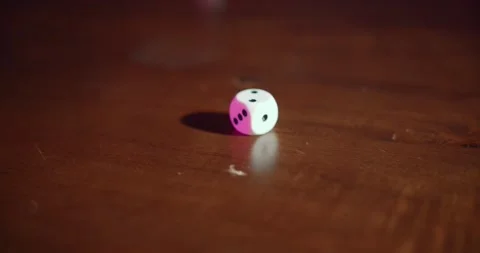 Rolling dice over a wooden table in slow motion Stock Footage 195298991