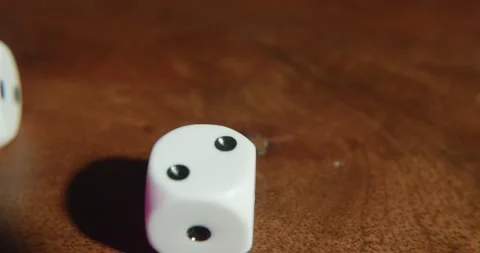 Rolling dice over a wooden table in slow motion Stock Footage 195299090