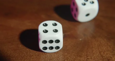 Rolling dice over a wooden table Stock Footage 195299093