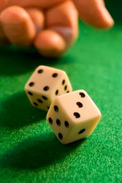 Rolling dice Stock Photos