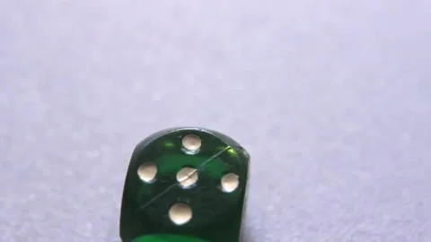 Rolling dice stops on digit 5, object close up Stock Footage 194973747