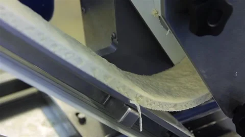 Rolling dough for dumplings -  feed dough into the machine Stock Footage 61878834