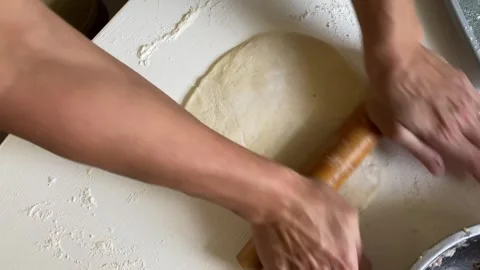Rolling Dough on Flour-Covered Table Stock Footage 315345615