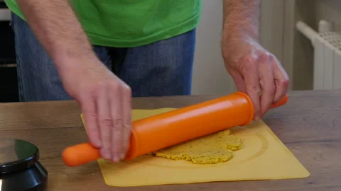Rolling dough on kitchen table. Male hands rolling dough.  스톡 동영상 217439834