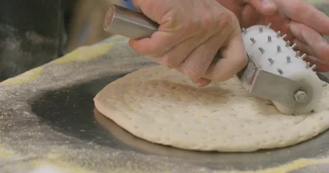 Rolling Dough Roller Docker Over Pizza Dough in Restaurant Kitchen - Slow Motion Stock Footage 87031390