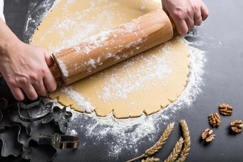 Rolling dough with roller. Stock Photos