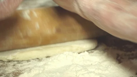 Rolling dough with rolling pin for baking, SLOW MOTION Stock Footage 100311567