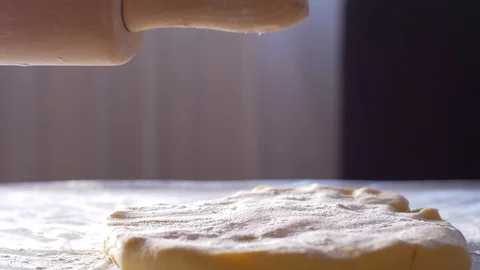 Rolling a dough with a rolling pin Видео 104432948