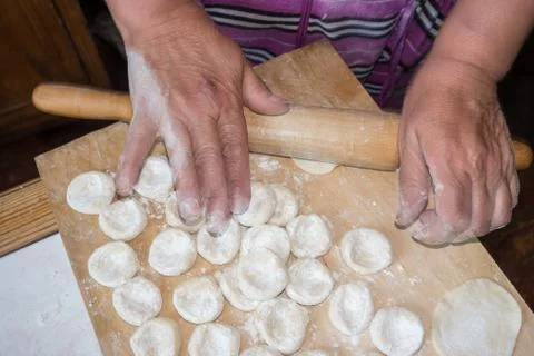 Rolling the dough with a rolling pin. Stock Photos