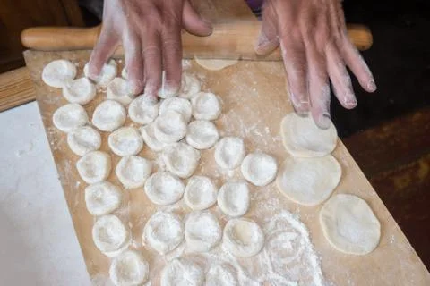 Rolling the dough with a rolling pin. Stock Photos