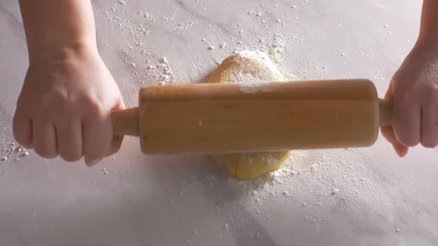 Rolling a dough with a rolling pin. Top view Stock Footage 104432712