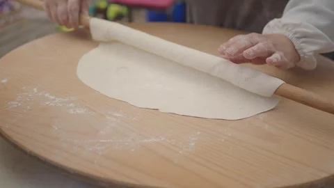 Rolling dough on a wooden surface for cooking Stock Footage 342780796