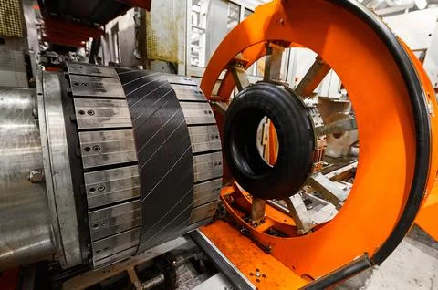 Rolling drum with rubber layers to form car tire at plant Stock Photos