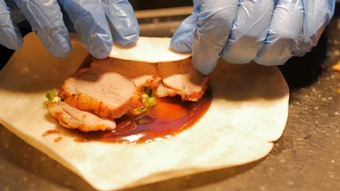 Rolling up duck wrap with gloves Stock Footage 94928410