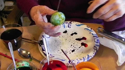 Rolling Egg In Speckled Paint Stock Footage 150316544